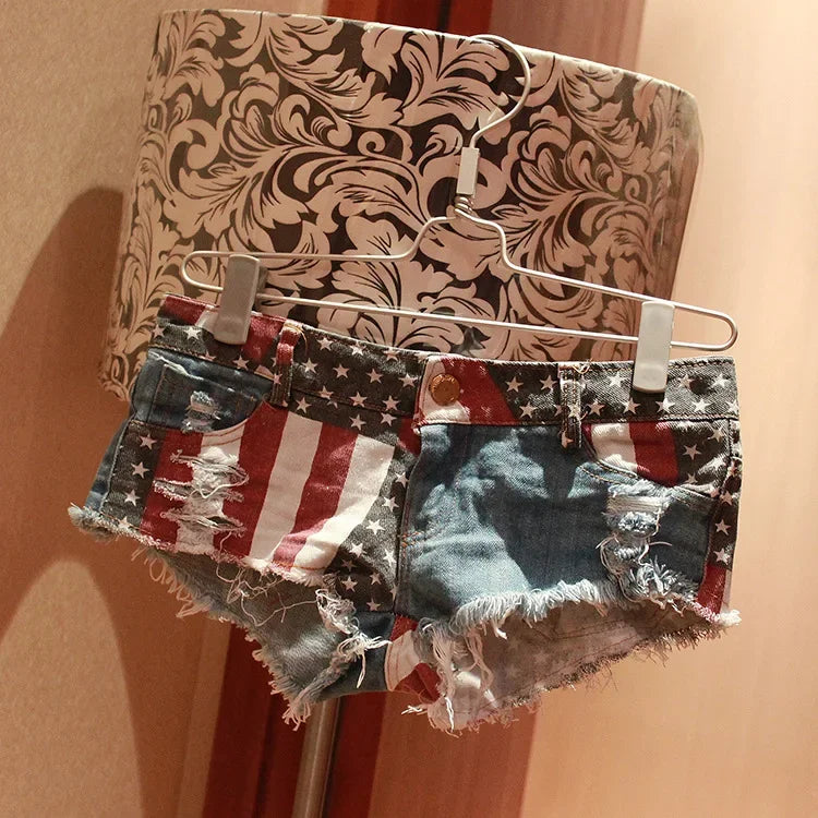 Women's American flag print ripped denim shorts by FLIPSTYLEZLLC, low-rise summer mini shorts with distressed details.