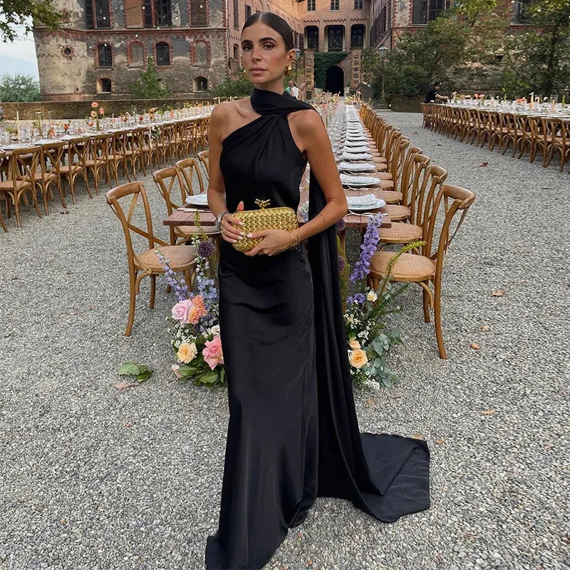 Backless lace-up maxi dress by Femstylo featuring sleeveless design and ribbon details, perfect for elegant evening occasions.