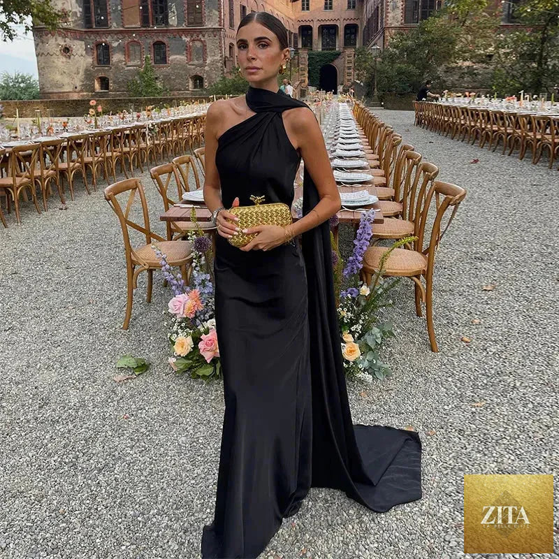 Backless lace-up maxi dress by Femstylo featuring sleeveless design and ribbon details, perfect for elegant evening occasions.