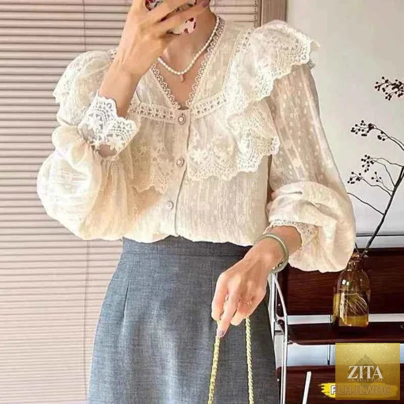 White elegant blouse with ruffles and long sleeves, suitable for office wear, by Corporación Turística.