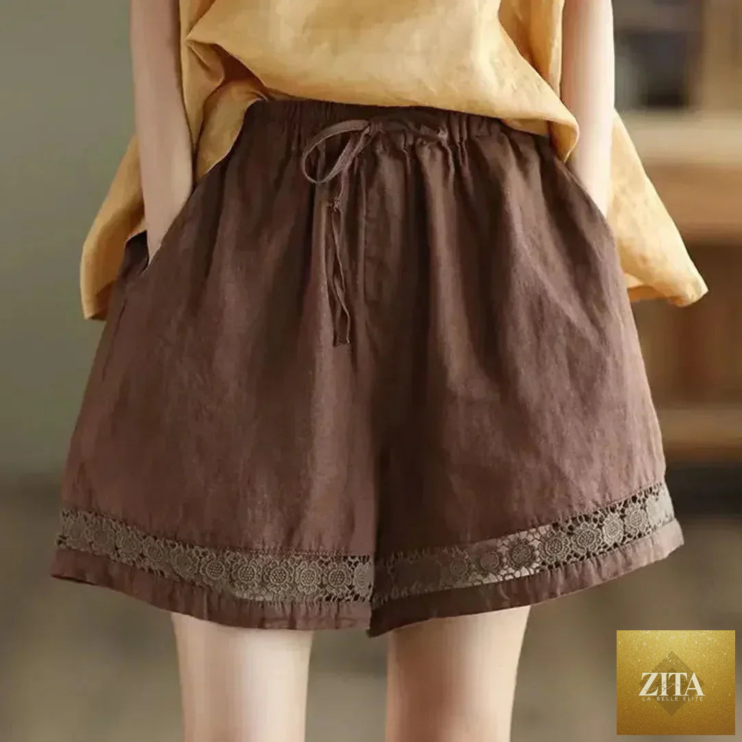 Cotton linen vintage high-waist shorts by Femstylo with tie belt, embroidered hollow design, casual straight fit.