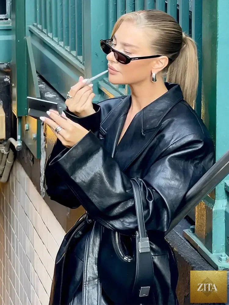 Women's long PU leather jacket with polo collar and lace details from FitiqueFit, featuring a stylish leather coat design.
