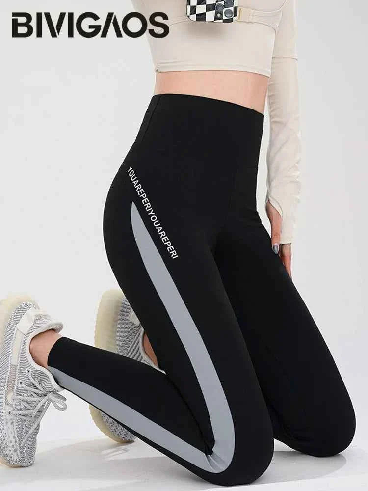 Striped Shark Butt Lift Leggings by THRIXINE featuring elastic fit and bold stripe design, shown on a model.