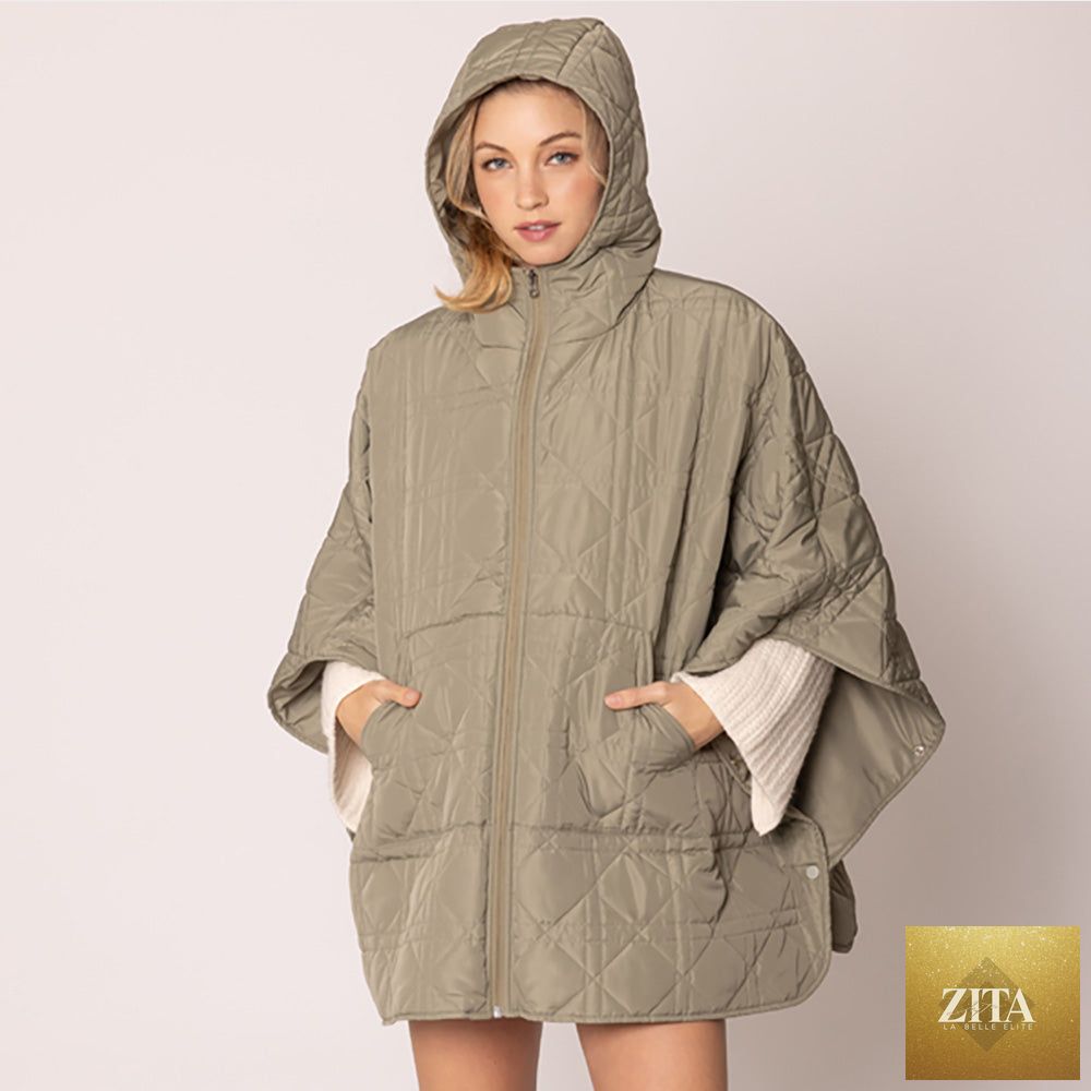 Madeline Love puffer cape poncho in quilted fabric, stylish outerwear with a cozy, oversized fit for cold weather.