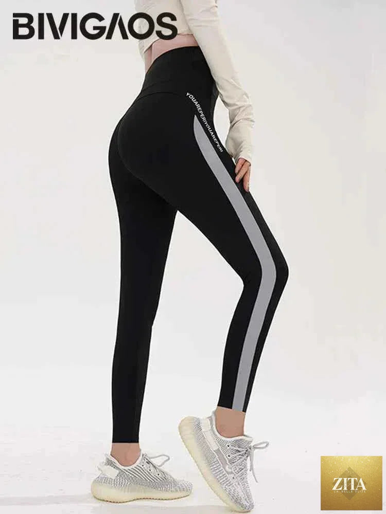 Striped Shark Butt Lift Leggings by THRIXINE showcasing elastic fit and bold striped pattern on a model.