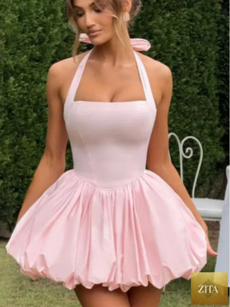 Women's pink corset mini dress with puffball hem, casualwear by Zita La Belle Elite, showcasing the fitted bodice and playful hem detail.