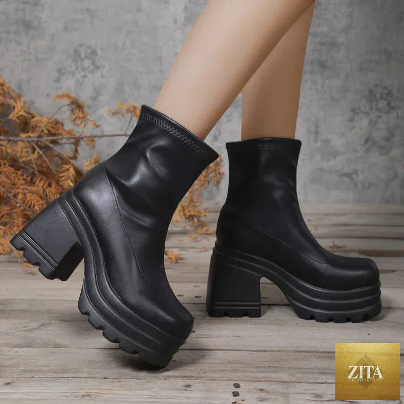 Women’s black leather short boots with square toes, high heels, zipper front, and thick soles, perfect for casual and fashionable looks.
