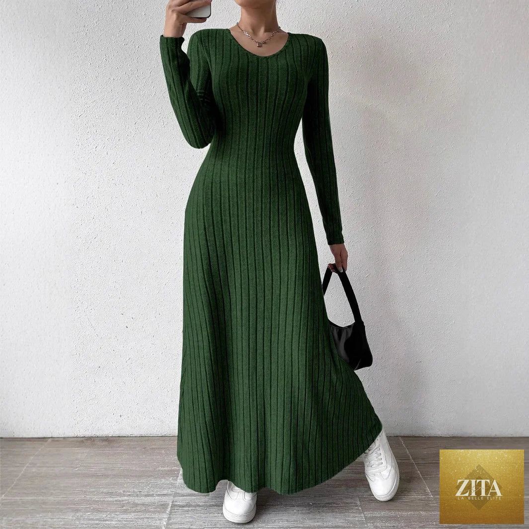 Women’s knitted elegant winter maxi dress with O-neck and long sleeves, stylishly worn by a model.