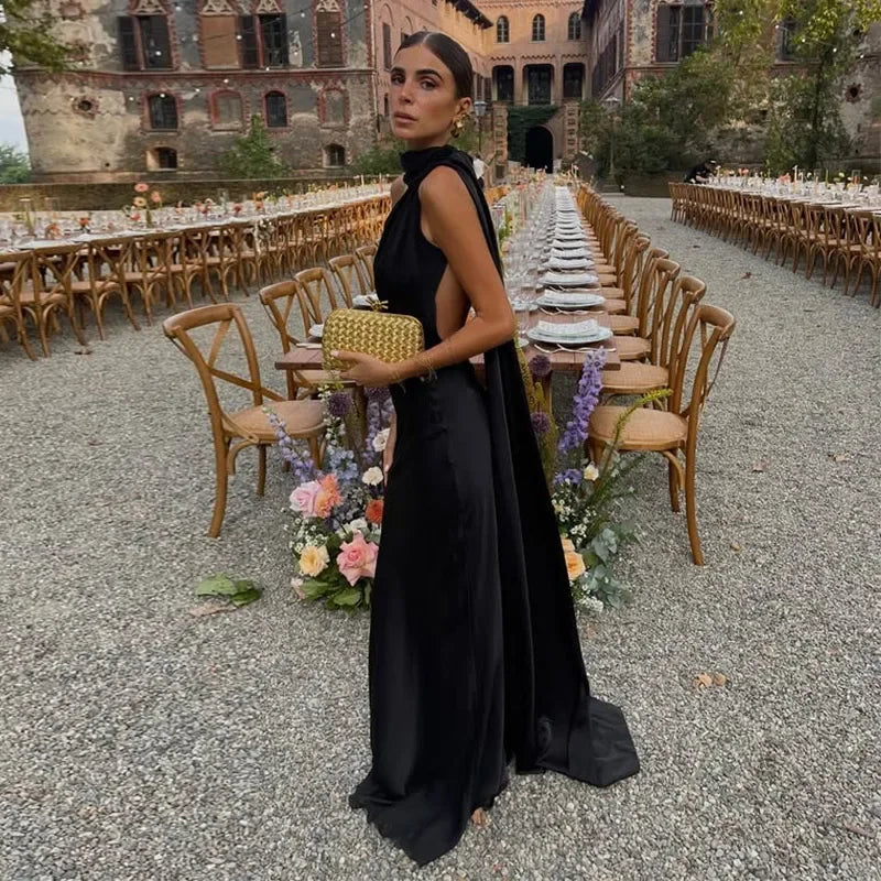 Backless lace-up maxi dress by Femstylo featuring a sleeveless design and ribbon details, perfect for elegant evening occasions.