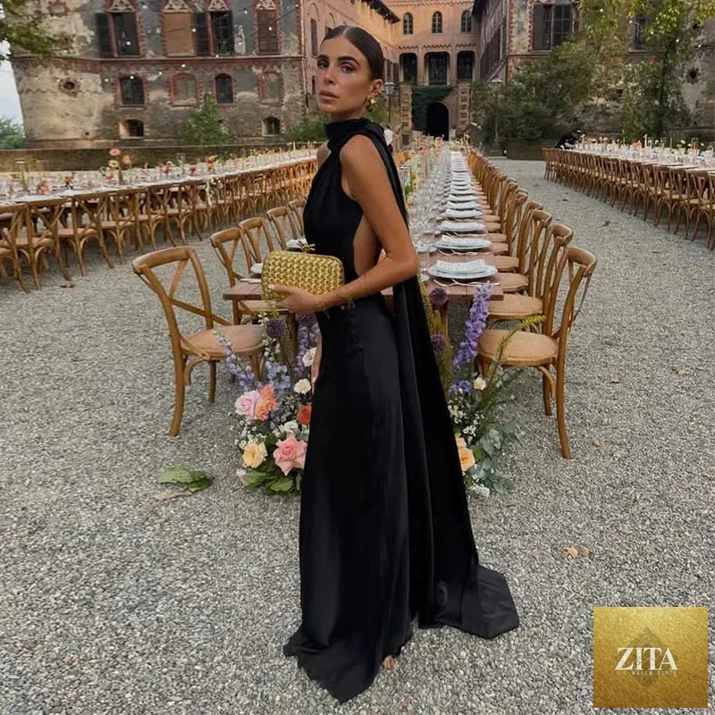 Backless lace-up maxi dress by Femstylo featuring a sleeveless design and ribbon details, perfect for elegant evening occasions.