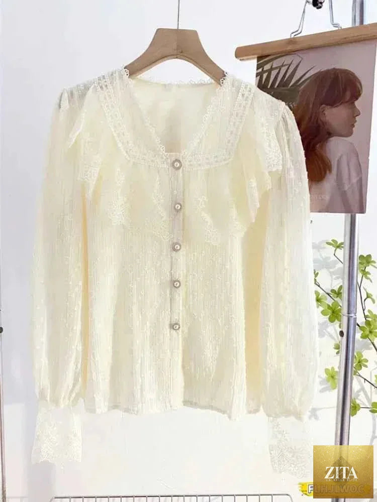 Elegant white blouse with ruffled details and long sleeves, perfect for office wear, by Corporación Turística.