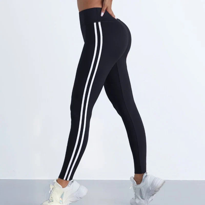Women's striped yoga leggings by 24 Hour Sport, form-fitting athletic pants with colorful stripe pattern for active wear.