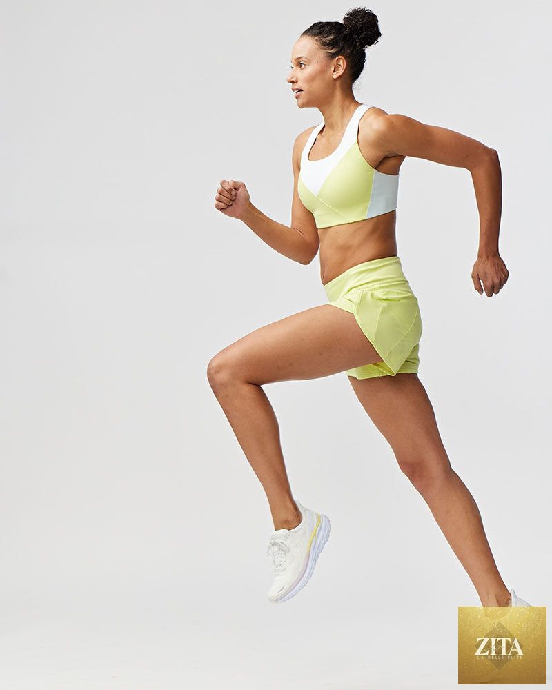 Sheva women's high rise training running shorts in lime light color with breathable fabric and athletic fit.