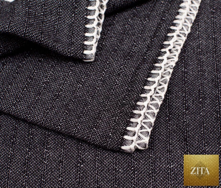 Black Turkish towel by Zita La Belle Elite without fringe, shown folded with textured fabric and woven design.