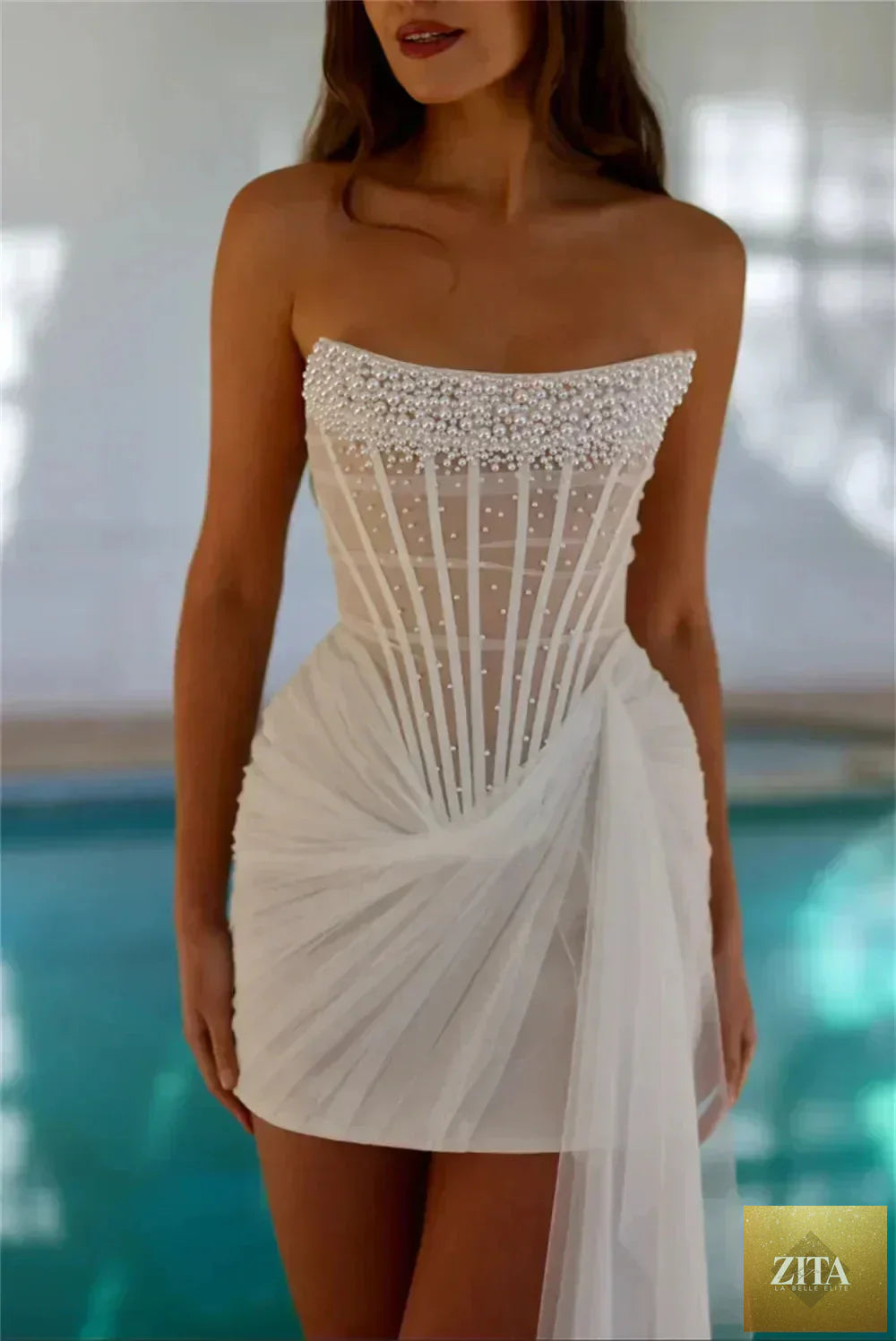 Femstylo Kyoto ivory strapless pearl-embellished mini wedding dress with pleated design and asymmetrical sleeveless style for after-party.