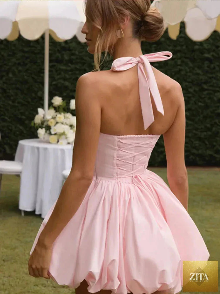 Women’s pink corset puffball-hem mini dress by FitiqueFit, featuring a fitted bodice and playful puffball hem for casual wear.