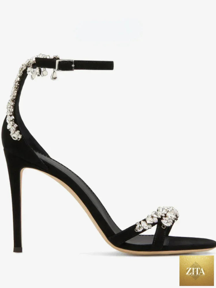 Black women's stiletto heels with open toe, rhinestone accents, slotted buckle, and round toe design by SHOMICOBOUTIQUE.