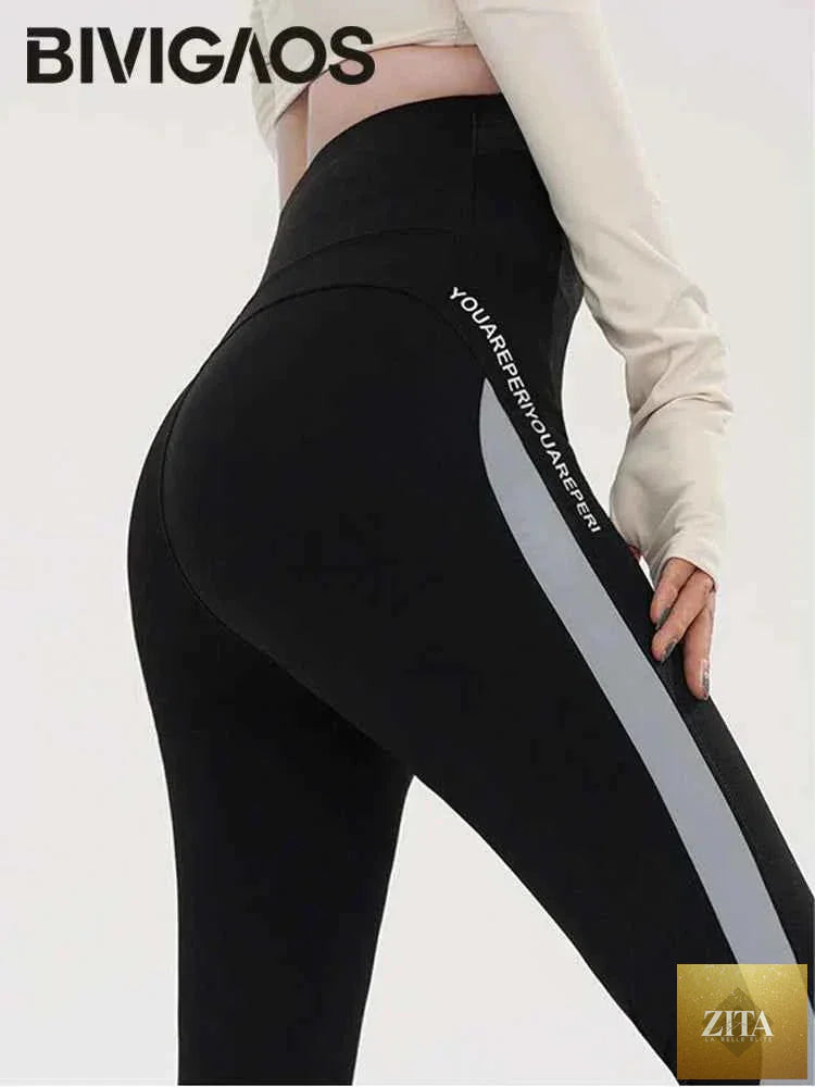 Striped Shark Butt Lift Leggings by THRIXINE featuring an elastic fit and bold striped pattern, designed to enhance curves and provide comfort.
