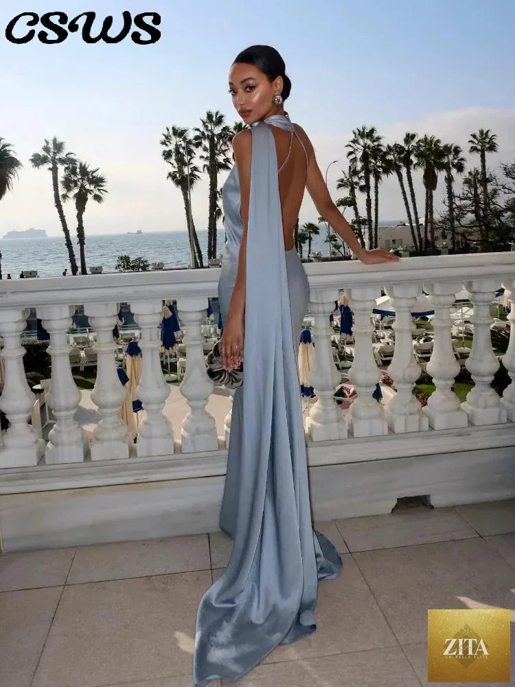 Backless lace-up maxi dress by Femstylo featuring sleeveless design and elegant ribbon details, perfect for evening parties.