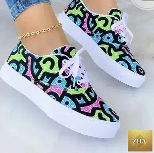 Women’s 2022 Graffiti Sneakers by Femstylo featuring vibrant urban graffiti design on stylish athletic footwear.