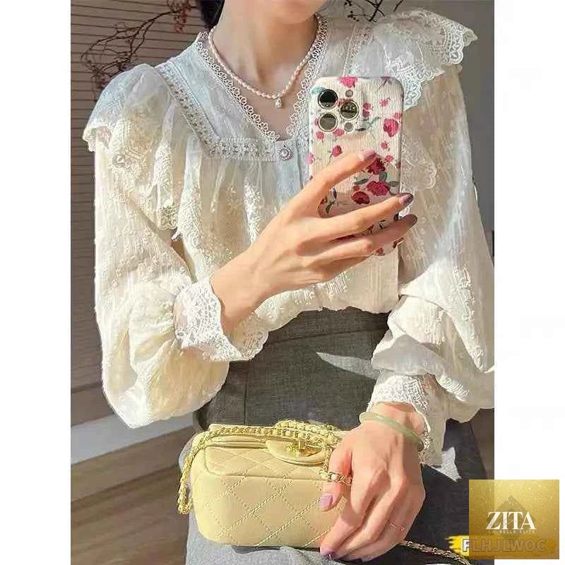 Elegant white blouse with ruffled details and long sleeves, suitable for office wear, by Corporación Turística.