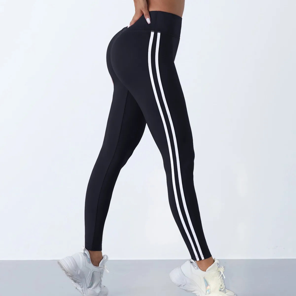 Women's striped yoga leggings by 24 Hour Sport featuring comfortable fit and stylish black and white striped pattern.
