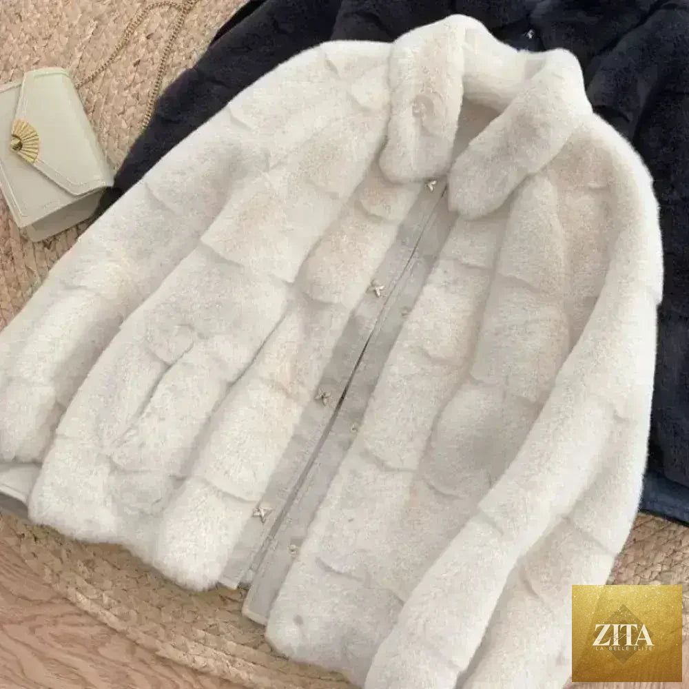 White faux fur jacket with vegan leather trimmed cuffs from Zita La Belle Elite, showing the plush fur and stylish details.