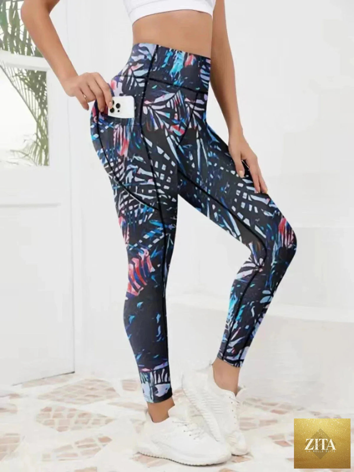 Women’s printed high-waist fitness leggings with side pockets by FitiqueFit, featuring colorful geometric patterns and stretchy fabric.