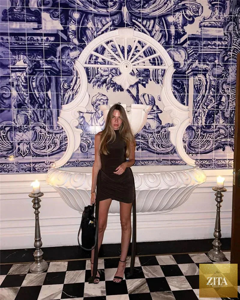 Femstylo sleeveless turtleneck mini dress with ruched, asymmetrical design, perfect for parties, shown in black on a model.