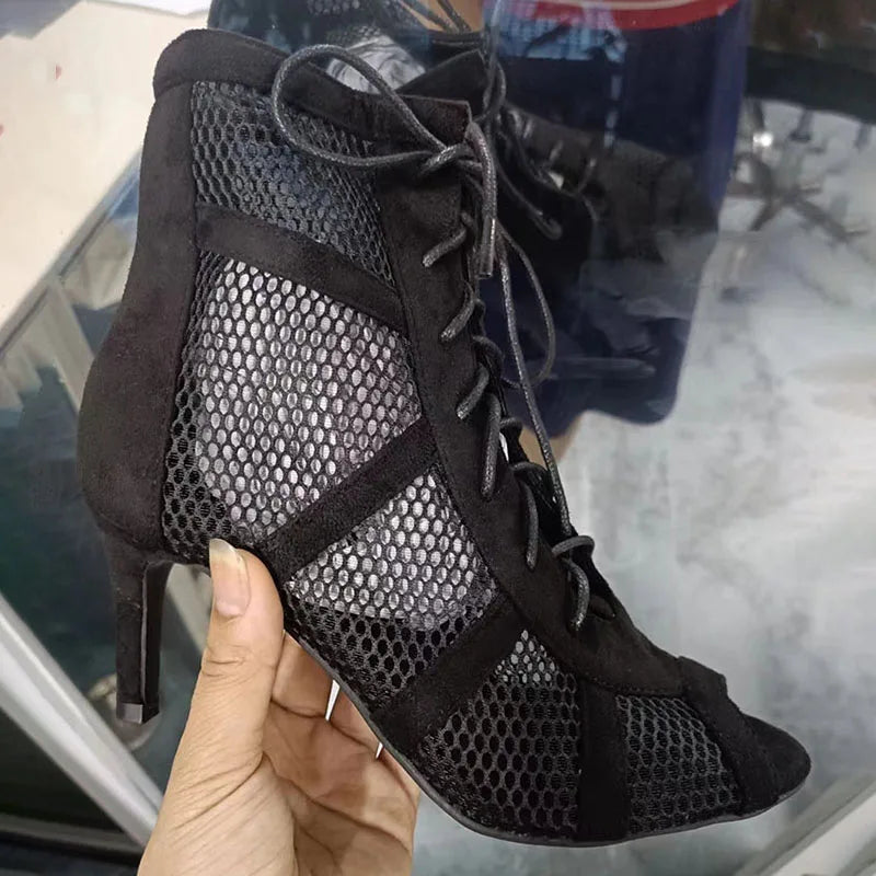 Black lace-up cross-tied women's high heel dancing sandals with open toe, ankle strap, and hollow-out design.