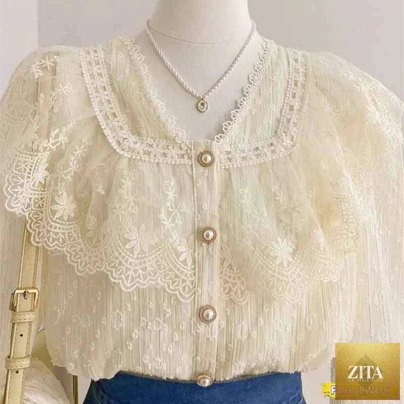 Elegant white blouse with ruffle details and long sleeves, ideal for office wear, by Corporación Turística.