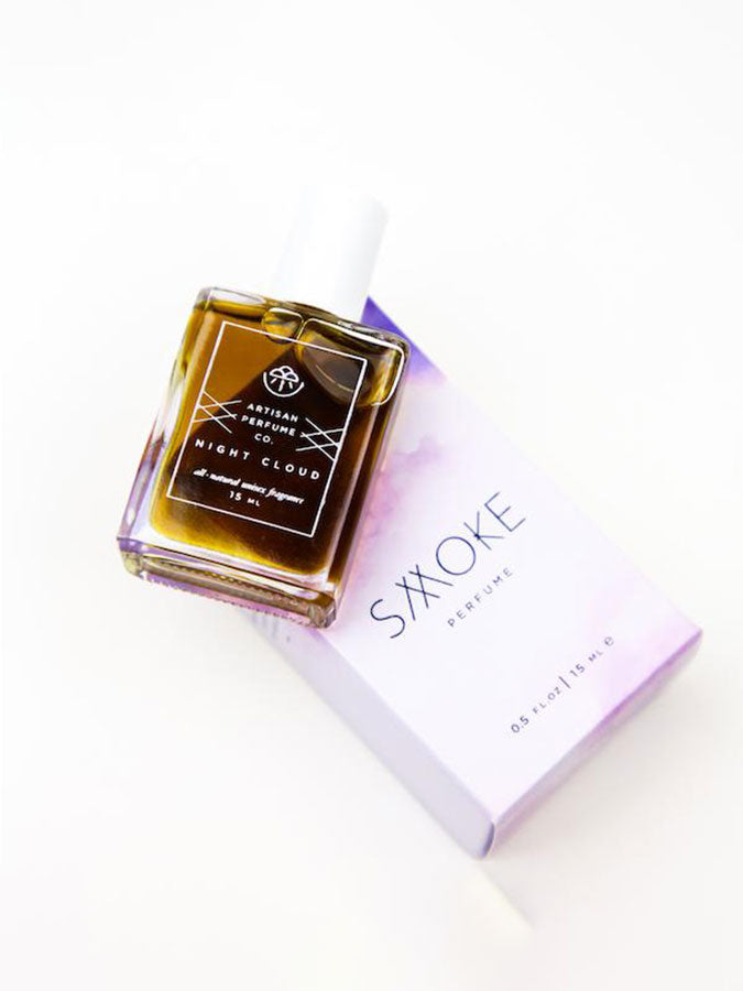 Elegant bottle of Smoke Perfume Night Cloud perfume with dark and sleek design, showcasing a luxurious fragrance.