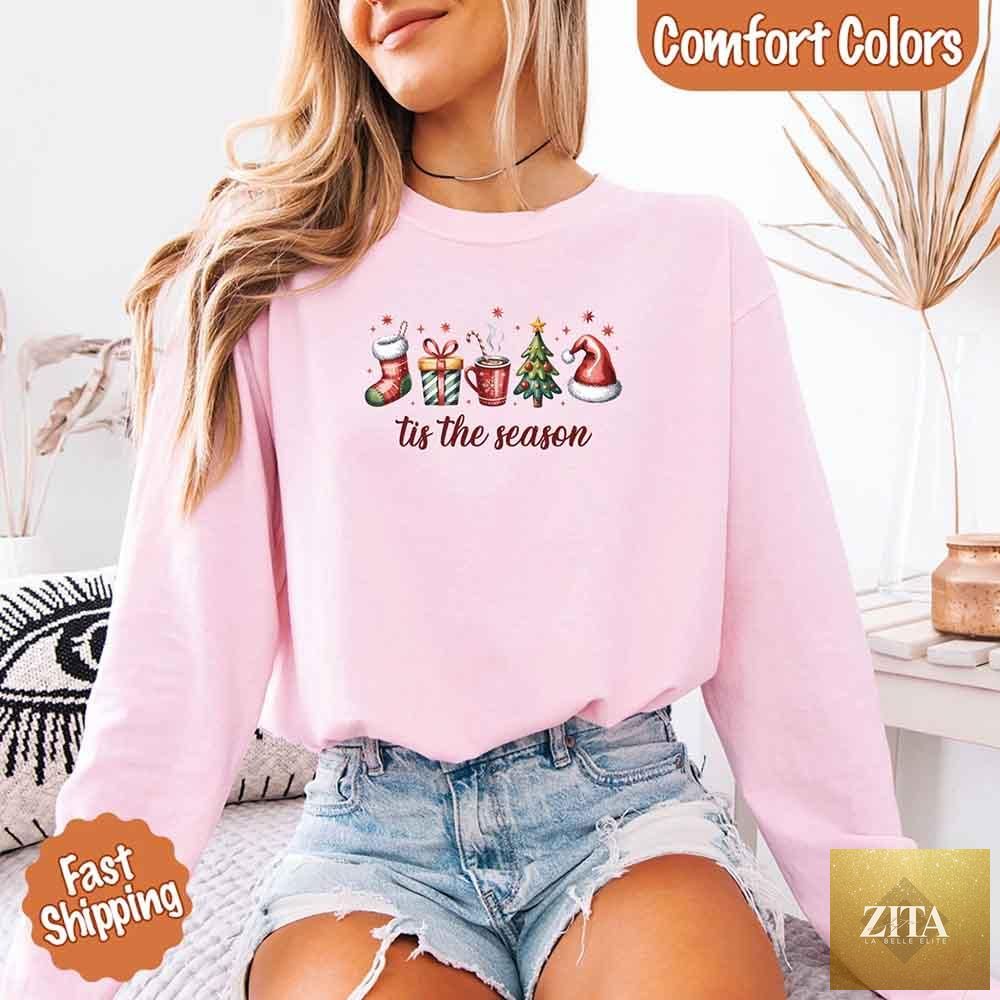 Comfort Colors long sleeve Christmas shirt with "Tis The Season" graphic, featuring festive holiday design and cozy fabric.