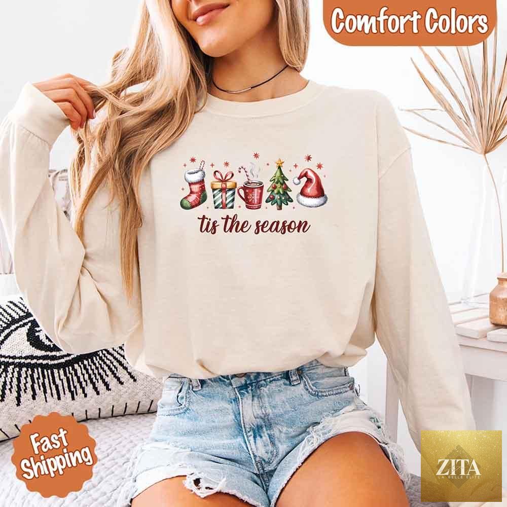 Comfort Colors long sleeve Christmas shirt with festive "Tis The Season" design, featuring holiday-themed graphics for seasonal wear.