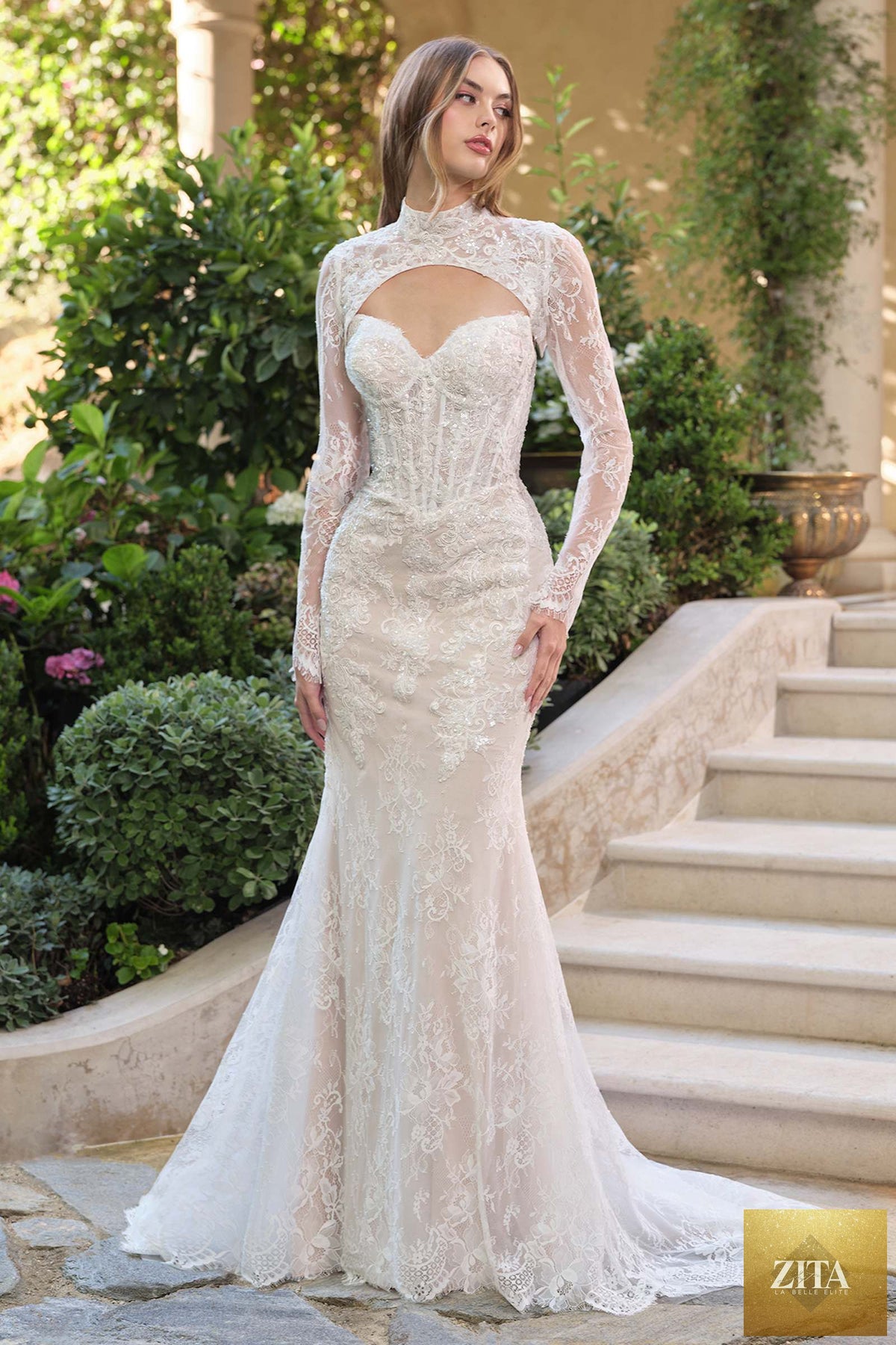 White fit and flare lace overlay wedding dress with nude accents, featuring a bolero jacket, by Andrea & Leo.