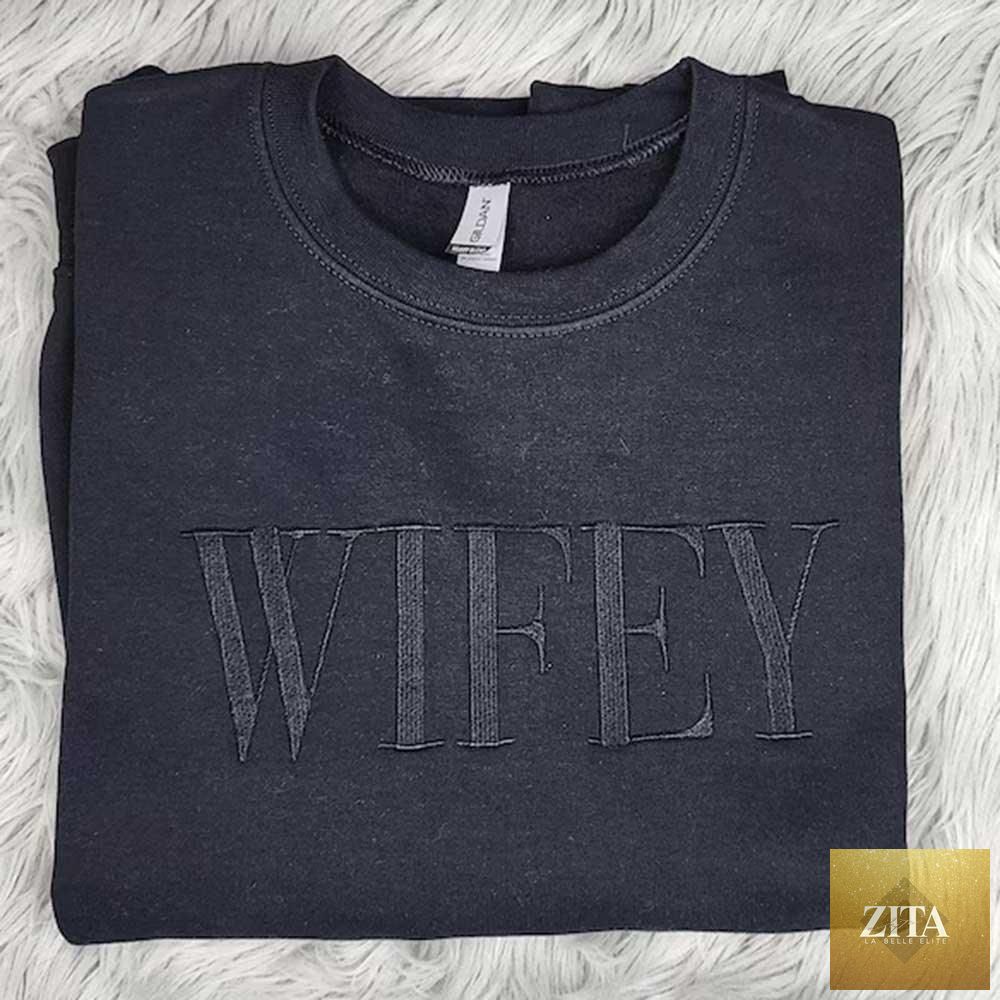 Black embroidered "Wifey" sweatshirt by Adorb Custom Tees featuring a cozy crewneck and stylish statement design.