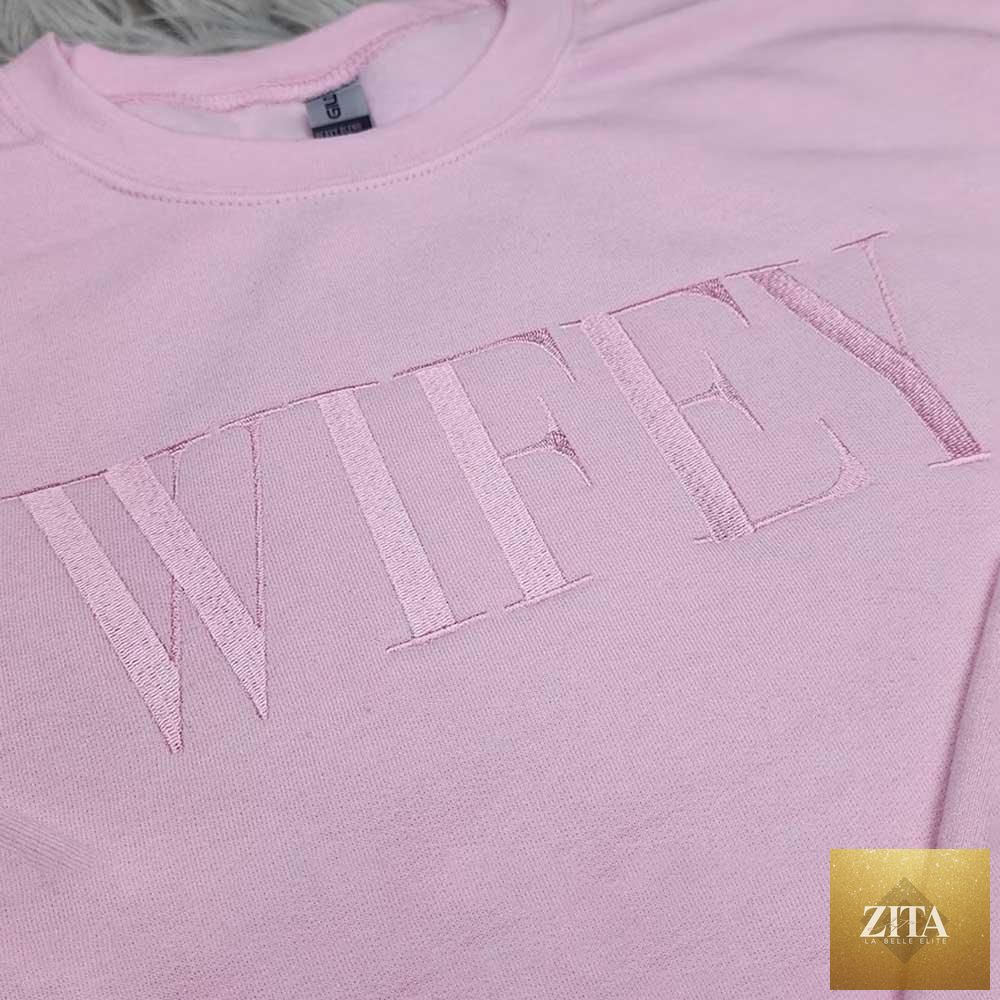 Pink embroidered "Wifey" sweatshirt by Adorb Custom Tees featuring a cozy crewneck and stylish statement design.