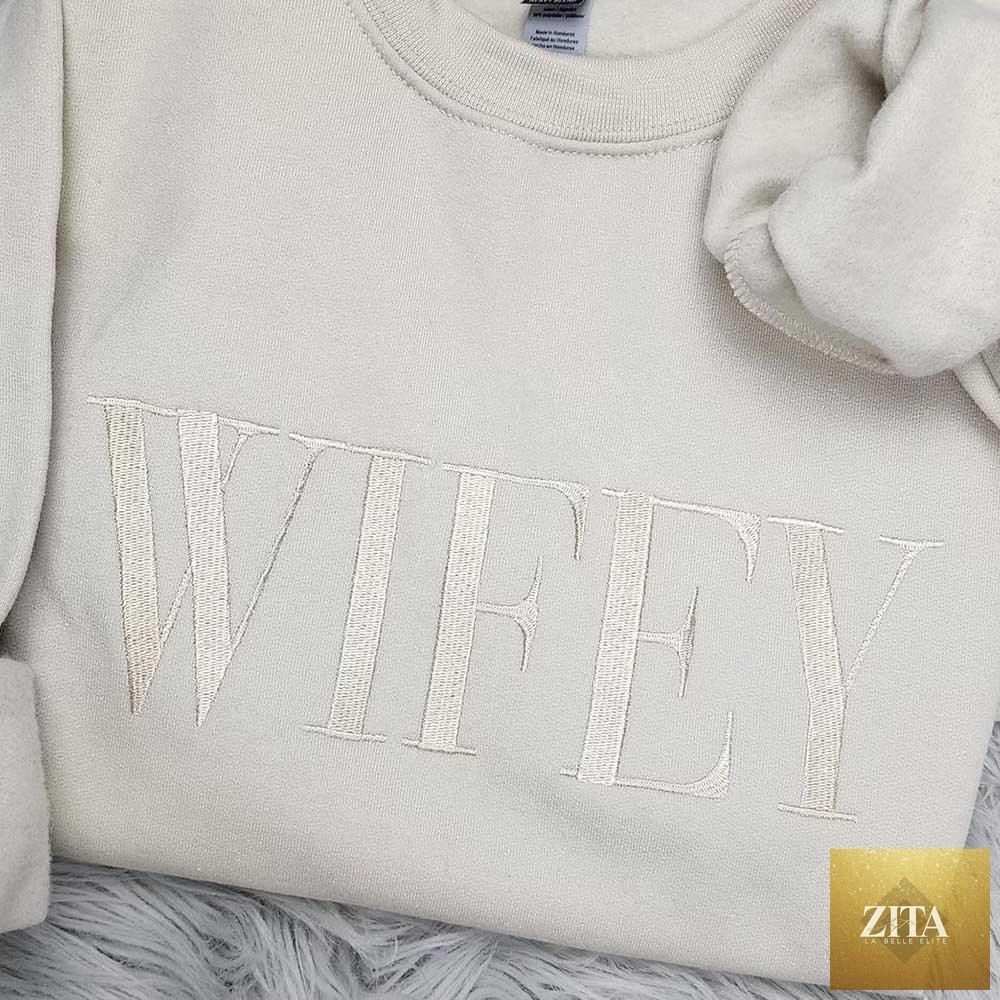 Embroidered "Wifey" sweatshirt by Adorb Custom Tees, cozy crewneck in champagne sand color, perfect gift for her.