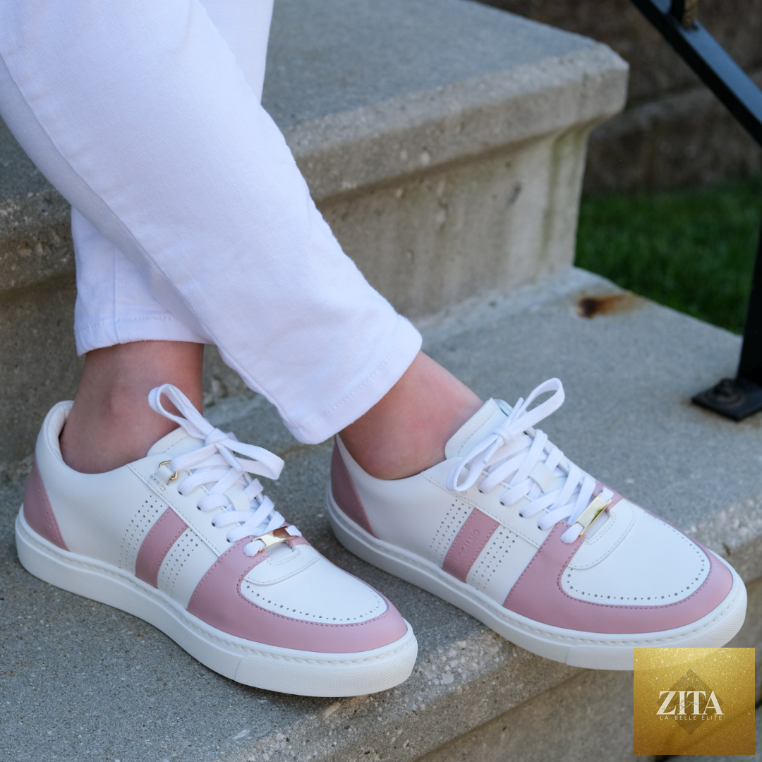 Woman wearing MOCALMO Women's Norma Rose Pink sneakers with white pants, showcasing stylish and comfortable athletic footwear.