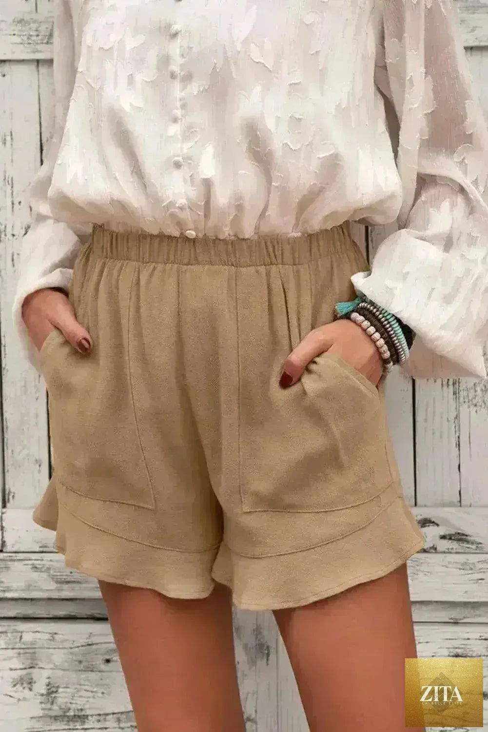 Women’s khaki flutter shorts by Femstylo with side pockets, made of lightweight linen and cotton for summer wear.