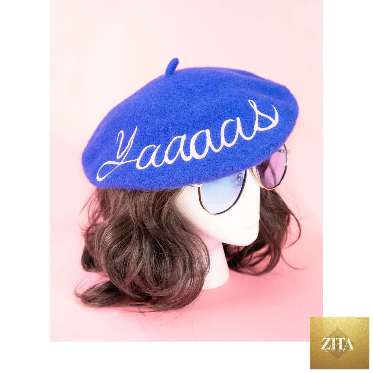 Blue embroidered beret hat by The Bullish Store featuring "Yaaaas" text design and stylish, soft fabric.