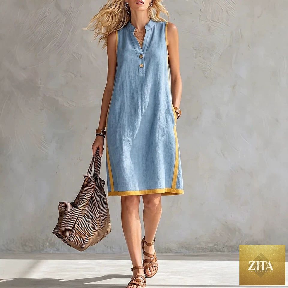 Women's sleeveless V-neck A-line midi dress with button front and pockets by FitiqueFit, casualwear style, shown with a flowing fabric.
