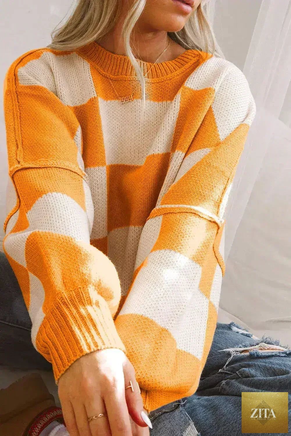 Orange checkered Femstylo bishop sleeve sweater with a cozy fit and stylish design, perfect for casual wear.