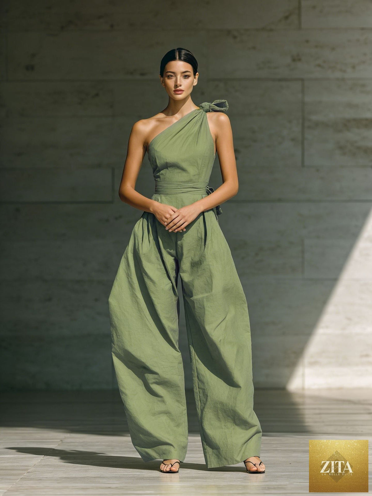 Women's loose, sleeveless off-shoulder wide-leg jumpsuit by Zita La Belle Elite, shown in a casualwear style with a belt.