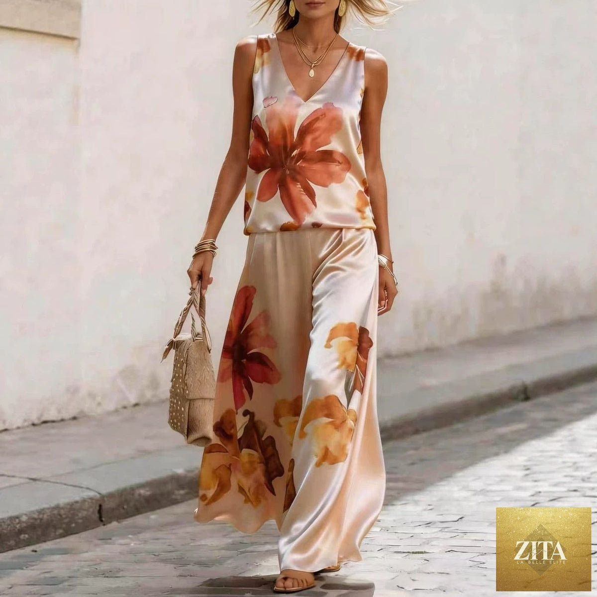 Women's sleeveless floral printed vest and pants two-piece set by Zita La Belle Elite, shown in a stylish water-themed photo.