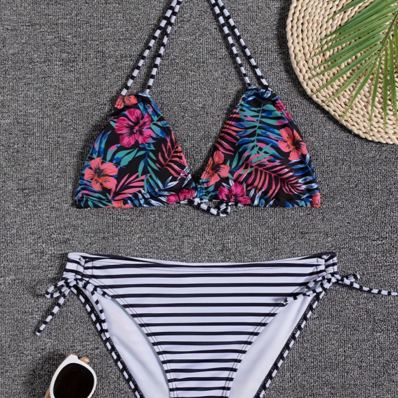 Stevvex Sunset Bloom 2-piece bikini set with vibrant floral print, halter neck, tie-back, and high-cut tie-side bottoms for women.