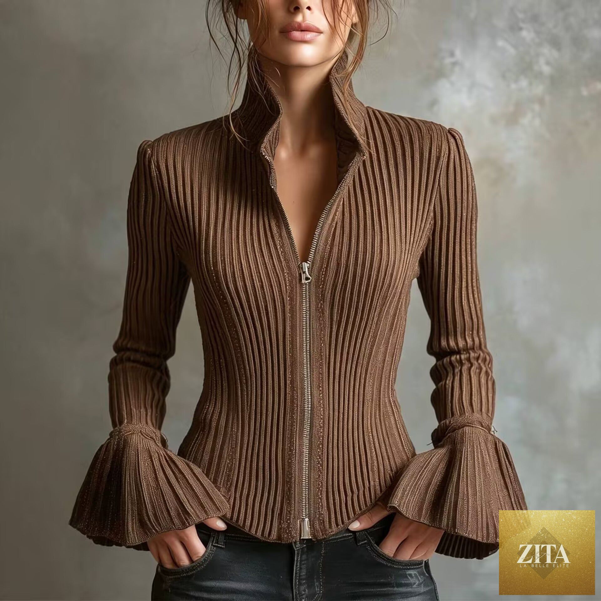 Women's slim-fit rib-knit zip-up top with flared cuffs by FitiqueFit, shown in a neutral color, close-up of the detailed knit fabric.