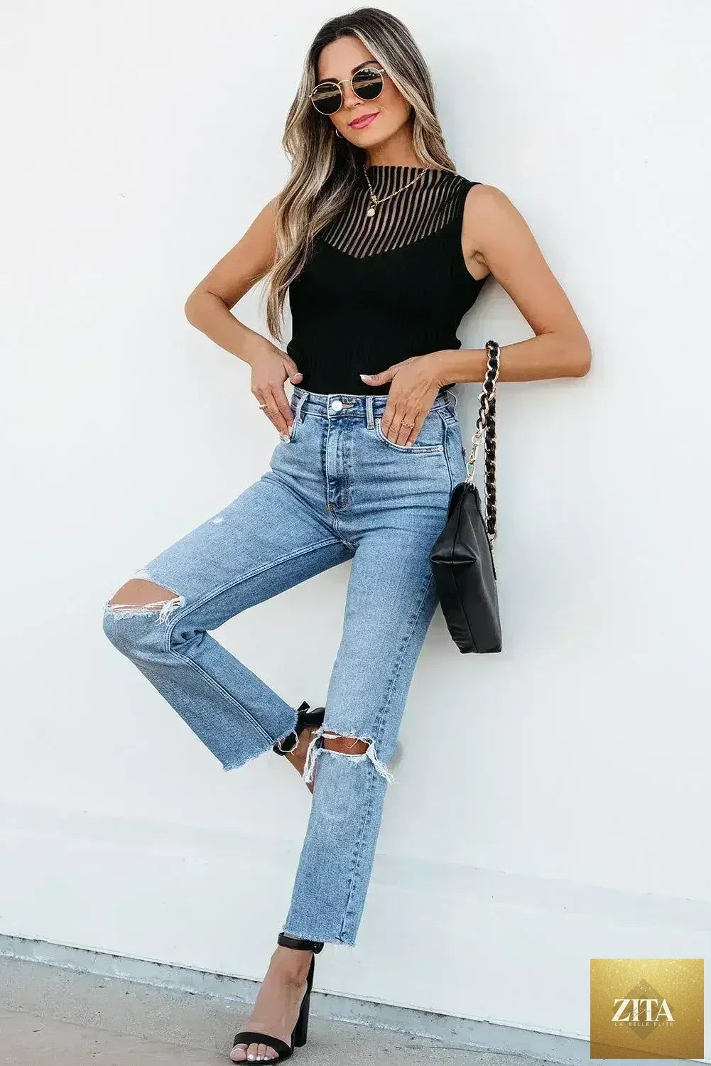 Black mesh cutout knit vest by Femstylo featuring edgy ribbed design, worn as a stylish top or blouse.