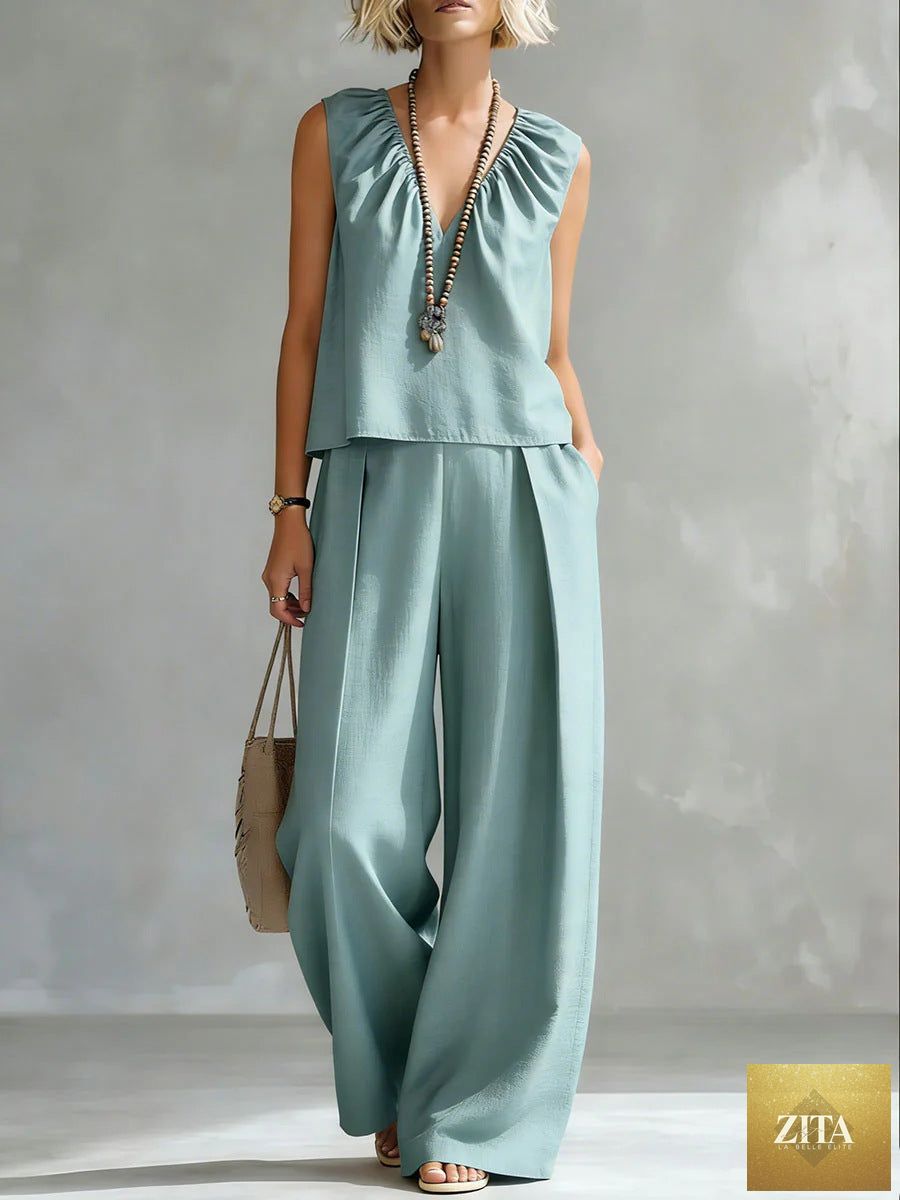 Women's sleeveless cotton-linen shirt and pants set by FitiqueFit, casual urban 2-piece outfit, shown in neutral tones.