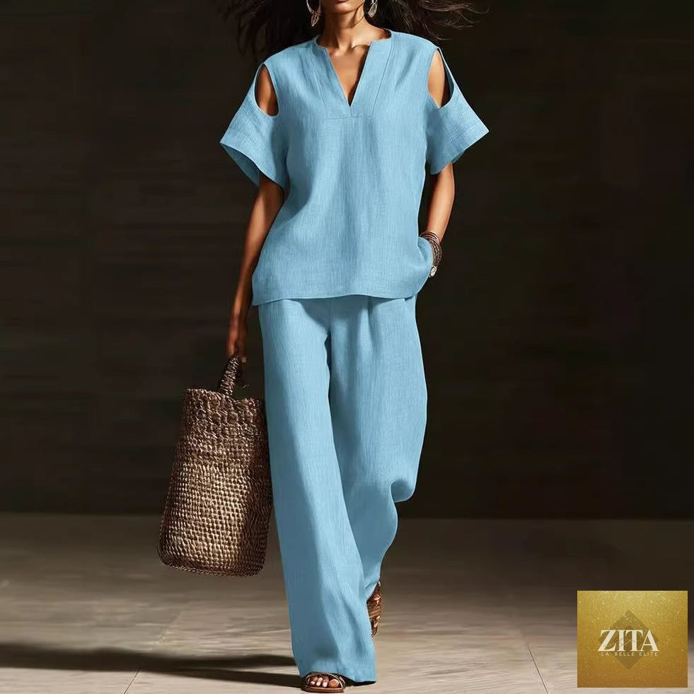 Zita La Belle Elite two-piece V-neck short sleeve top and straight-leg pants set with ripped details and pockets in a solid color.